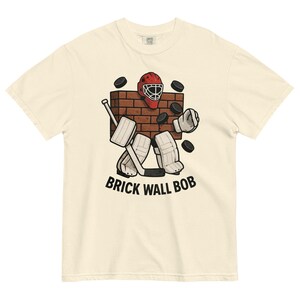 Brick Wall Bob Goalie Tee – Funny Hockey Goalie Shirt – Vintage Style Hockey T-Shirt – Retro Goalie Graphic Tee – Ice Hockey Gift for Fans