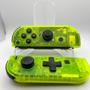 May include: A pair of neon green Nintendo Switch Joy-Con controllers. The top controller has the standard buttons, while the bottom controller has a larger D-pad.