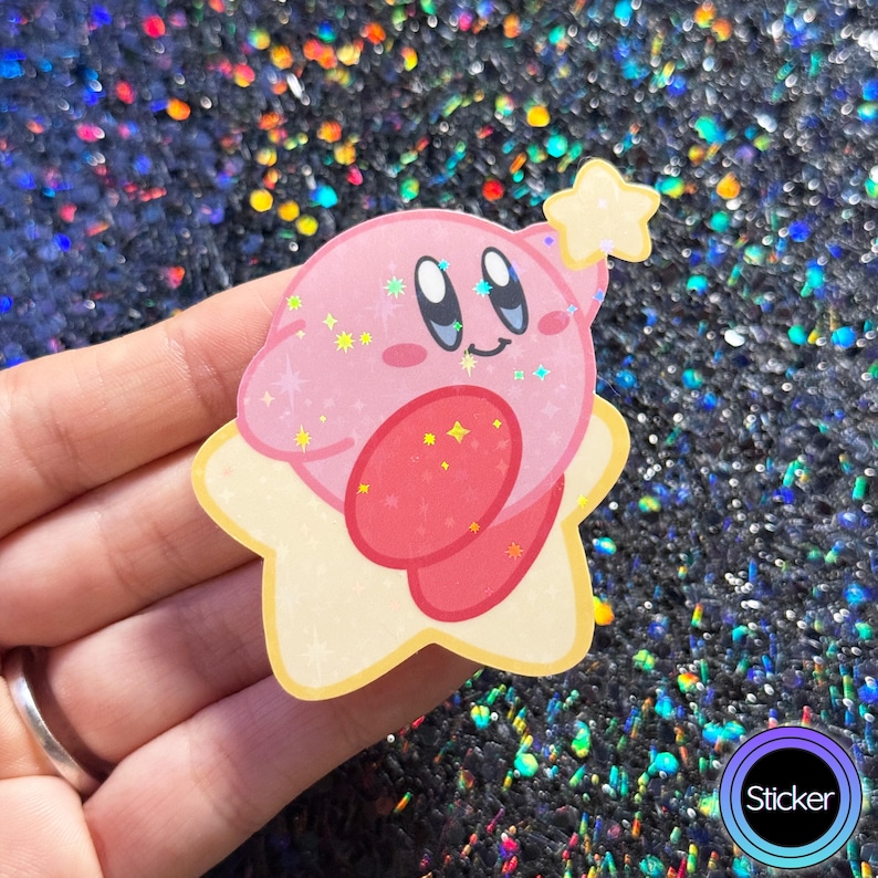 May include: A pink and yellow holographic sticker of a pink character with a star on its head. The character has a big smile and is holding a star in its hand.