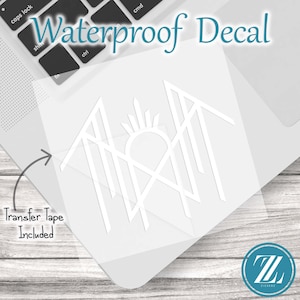 May include: A white waterproof decal featuring a geometric line art design of a sun rising over mountain peaks. The decal includes transfer tape and is displayed on a laptop surface. The text Waterproof Decal and Transfer Tape Included is visible.