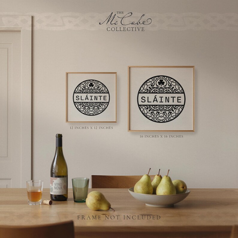 May include: Two square wall art prints in light wood frames featuring a black circular Celtic knot design with the word SL&Aacute;INTE in the center. The smaller print is 12 inches by 12 inches and the larger print is 16 inches by 16 inches.