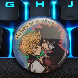 May include: A round button with a colorful background and two cartoon characters. The text "Halves of a Whole" is written in a rainbow font on the button.