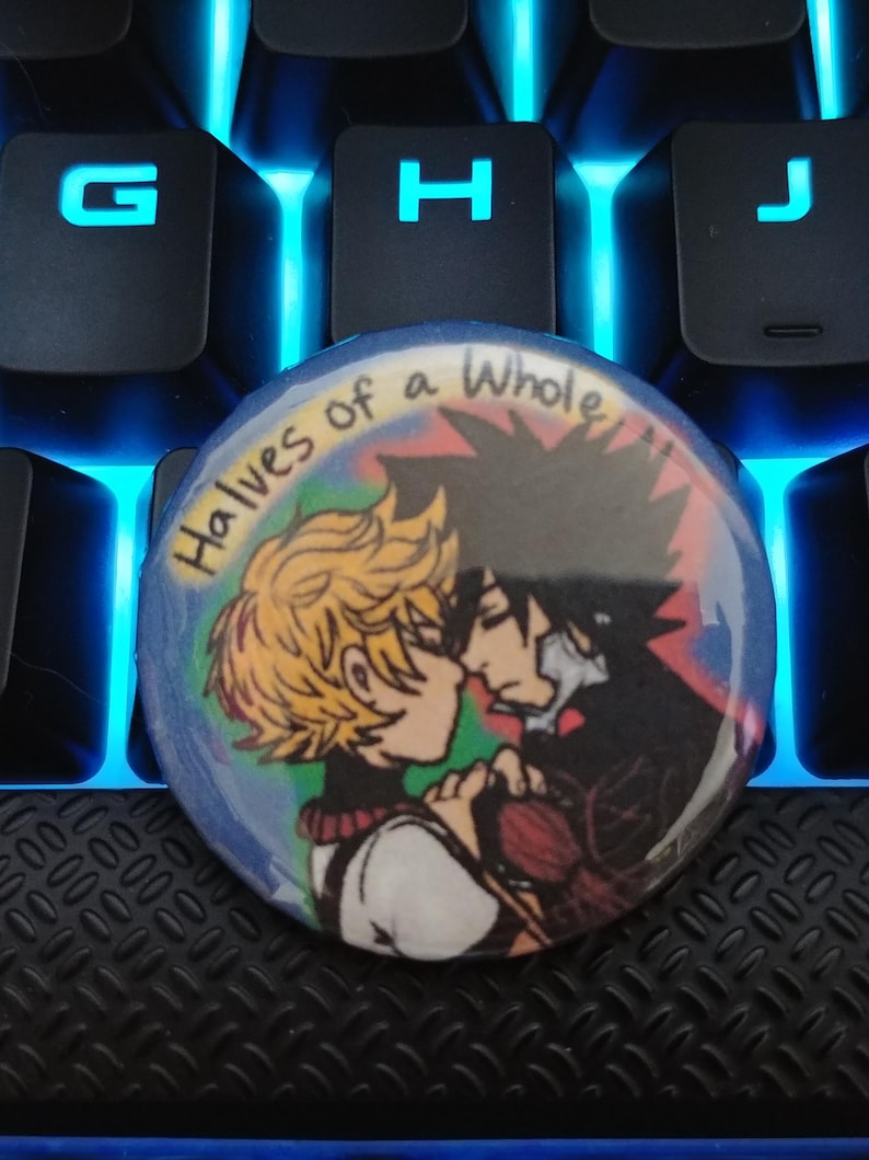 May include: A round button with a colorful background and two cartoon characters. The text "Halves of a Whole" is written in a rainbow font on the button.