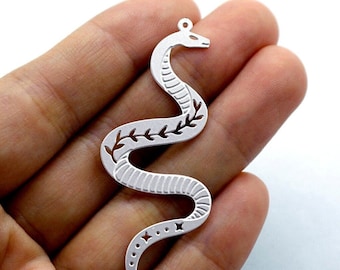 May include: Silver snake charm with a vine design and a dotted tail. The charm is cut out and has a textured surface.