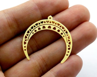 May include: Gold-toned metal crescent moon charm with a decorative cutout design. The charm has a small hole at the top for attaching to jewelry.
