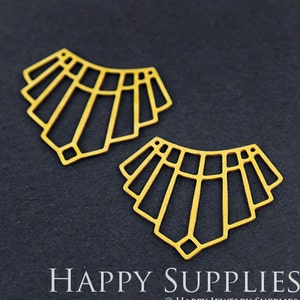 May include: Two gold metal geometric shapes with a fan-like design. The shapes are cut out and have a delicate, intricate design.