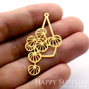 May include: Gold-toned metal pendant with a geometric design featuring a teardrop shape with a circle cutout and a dangling chain of five smaller circles with a cutout design.