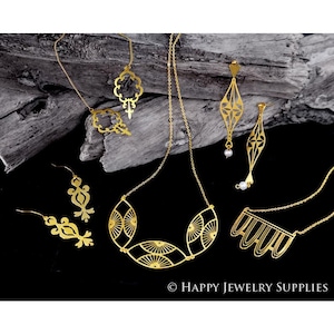 May include: A set of gold-toned jewelry featuring intricate geometric designs. The set includes a necklace, earrings, and a pendant. The jewelry is displayed on a wooden surface.