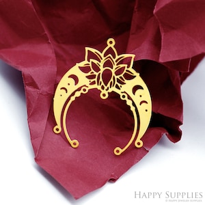 May include: Gold metal pendant featuring a crescent moon design with a lotus flower in the center. The pendant has a delicate, intricate design and is perfect for jewelry making.