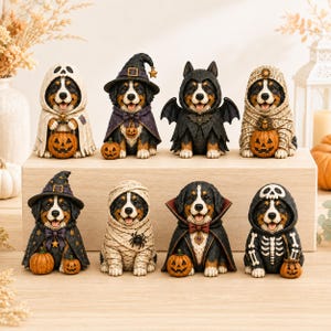 May include: A collection of eight Bernese Mountain Dog figurines dressed in various Halloween costumes, including ghosts, witches, vampires, mummies, and skeletons, each accompanied by small orange jack-o'-lantern pumpkins.