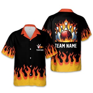 May include: Black bowling shirt with orange collar and cuffs, featuring a flame design. The front has a bowling pin graphic and "TEAM NAME" text. The back displays a bowling ball and pins engulfed in flames, with "TEAM NAME" text.