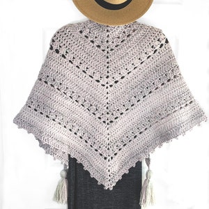 Crochet shawl in soft lilac color with a metallic thread in pastel rainbow colors