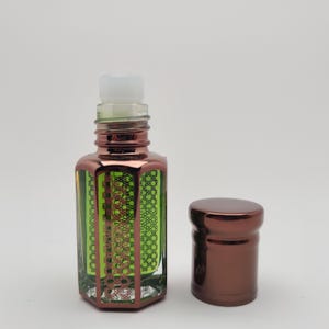 Mosswood Oud by RuhSafar perfume oil displayed in a sleek bottle with golden details, photographed on a pure white background for a luxury feel