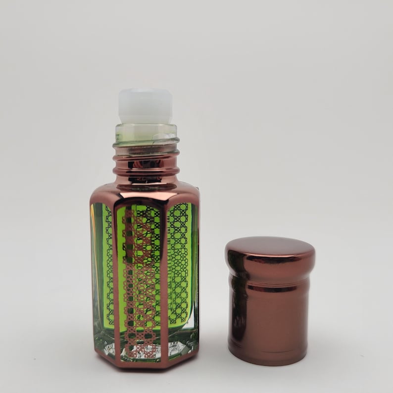Mosswood Oud by RuhSafar perfume oil displayed in a sleek bottle with golden details, photographed on a pure white background for a luxury feel