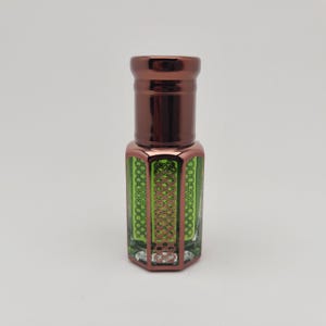 Studio-lit product photo of Mosswood Oud, a deep earthy and woodsy perfume oil, captured on a bright white background for a modern clean look