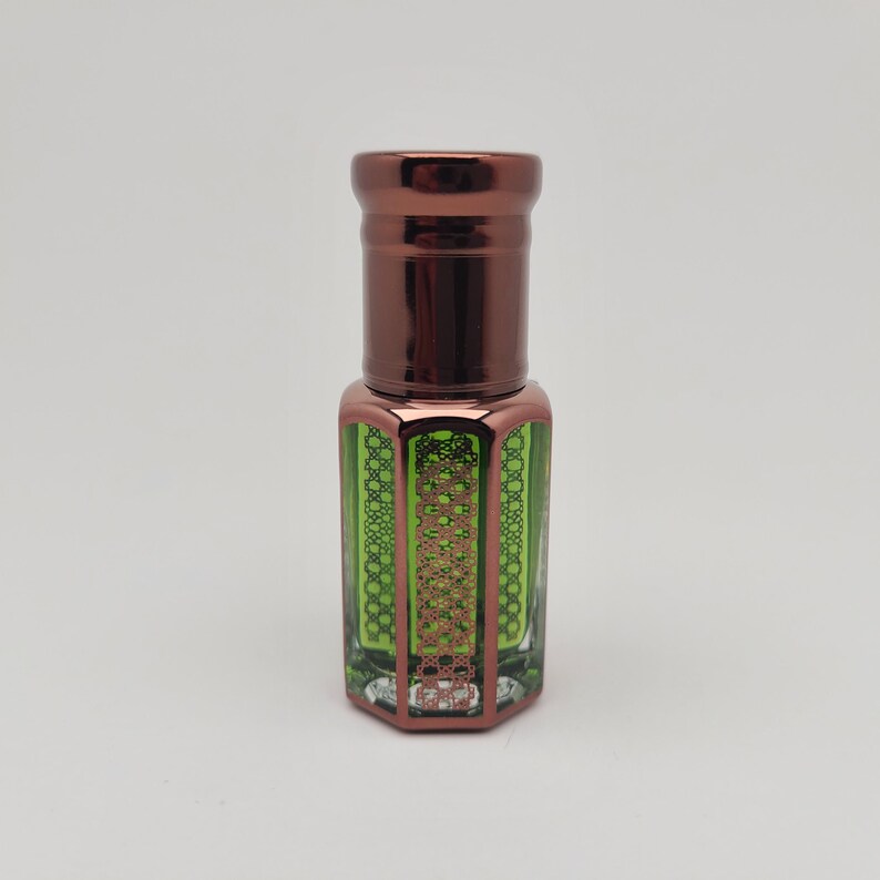 Studio-lit product photo of Mosswood Oud, a deep earthy and woodsy perfume oil, captured on a bright white background for a modern clean look