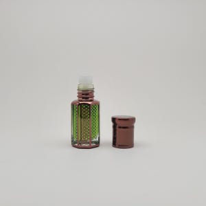 Mosswood Oud perfume oil bottle displayed against a clean white background, highlighting the clear glass design and minimal aesthetic