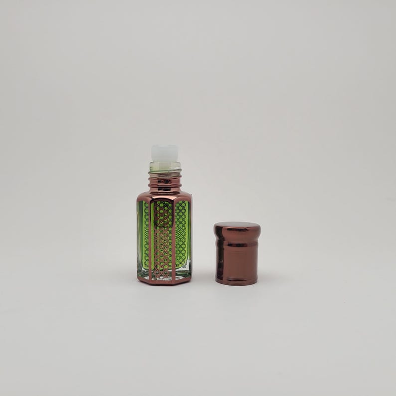 Mosswood Oud perfume oil bottle displayed against a clean white background, highlighting the clear glass design and minimal aesthetic