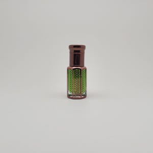 High-resolution image of Mosswood Oud attar, a unisex alcohol-free perfume oil presented in a minimalist glass bottle on a plain white surface