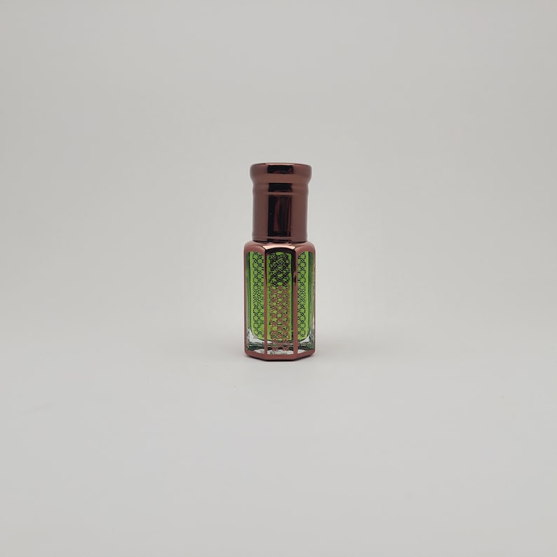 High-resolution image of Mosswood Oud attar, a unisex alcohol-free perfume oil presented in a minimalist glass bottle on a plain white surface