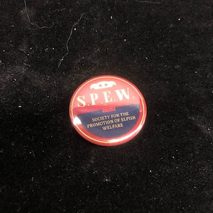 May include: A red and blue button with the text "S.P.E.W." and the words "Society for the Promotion of Elfish Welfare".