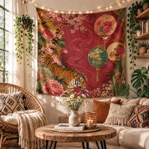 May include: A rectangular wall tapestry featuring a tiger walking through pink peony flowers and hanging lanterns against a deep red background with swirling patterns. The design includes detailed floral motifs and two circular lanterns.