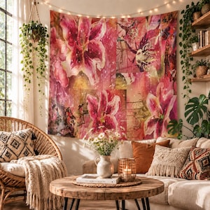 May include: A rectangular wall tapestry featuring a vibrant watercolour-style print of large pink and red lily flowers against a warm, abstract background with golden highlights and subtle textured patterns, hanging flat against a wall.