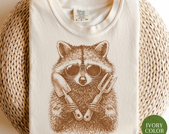 Gardening Raccoon Shirt, Comfort Colors® Plant Lover Tee, Cottagecore Shirt, Garden Gift For Her, Plant Mom Shirt, Cool Garden Humor