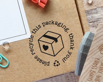 May include: A brown cardboard box with a black and white stamp that says "Please recycle this packaging, thank you". The stamp features a box with a heart and a recycle symbol.