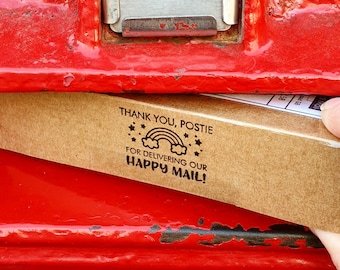 May include: A brown cardboard envelope with the text "Thank you, Postie for delivering our Happy Mail!" and a rainbow graphic.