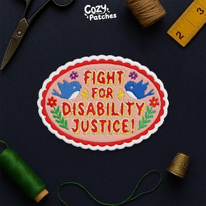 May include: Embroidered patch with the text "FIGHT FOR DISABILITY JUSTICE!" in yellow and red. The patch has a pink oval shape with a red scalloped border, blue birds, and floral accents. The patch is surrounded by sewing tools.