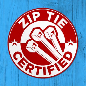 May include: A red and white circular sticker with the text "ZIP TIE CERTIFIED" in white lettering. Three white zip ties are shown in the center of the sticker.