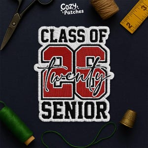 May include: Embroidered patch with the text "CLASS OF 26 SENIOR" in white and red. The number "26" is in a bold, outlined font. The word "twenty" is in a cursive font. The patch is on a dark blue background, with sewing tools.