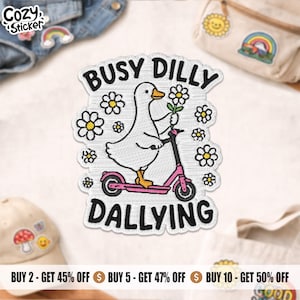 May include: Embroidered patch featuring a white goose riding a pink scooter and holding a flower. The patch has the words "BUSY DILLY DALLYING" in a playful font, surrounded by daisy-like flowers. The patch is from "Cozy Sticker".