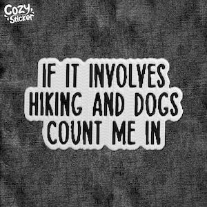 May include: White patch with black text on a denim background. The text reads "If it involves hiking and dogs count me in."