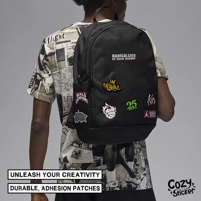 May include: Black backpack with multiple patches, including "RADICALIZED BY BASIC DECENCY", "WORLD CHAMPIONS", and a basketball design. The backpack has a side pocket and a top handle. The text "UNLEASH YOUR CREATIVITY" and "DURABLE, ADHESION PATCHES" are also visible.