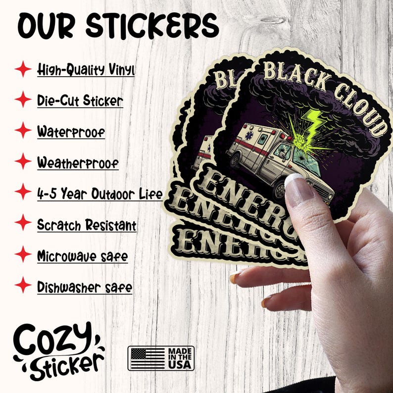 May include: A stack of die-cut stickers featuring a white ambulance with a green lightning bolt against a dark purple background. The stickers have the words "BLACK CLOUD" and "ENERGY" printed on them. The image also includes text that says "OUR STICKERS".
