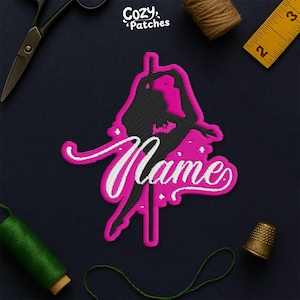 May include: A pink and black embroidered patch featuring a pole dancer silhouette with the word "Name" in white script. The patch is surrounded by sewing tools, including scissors, thread, and a thimble. The brand name "Cozy Patches" is in the upper left corner.