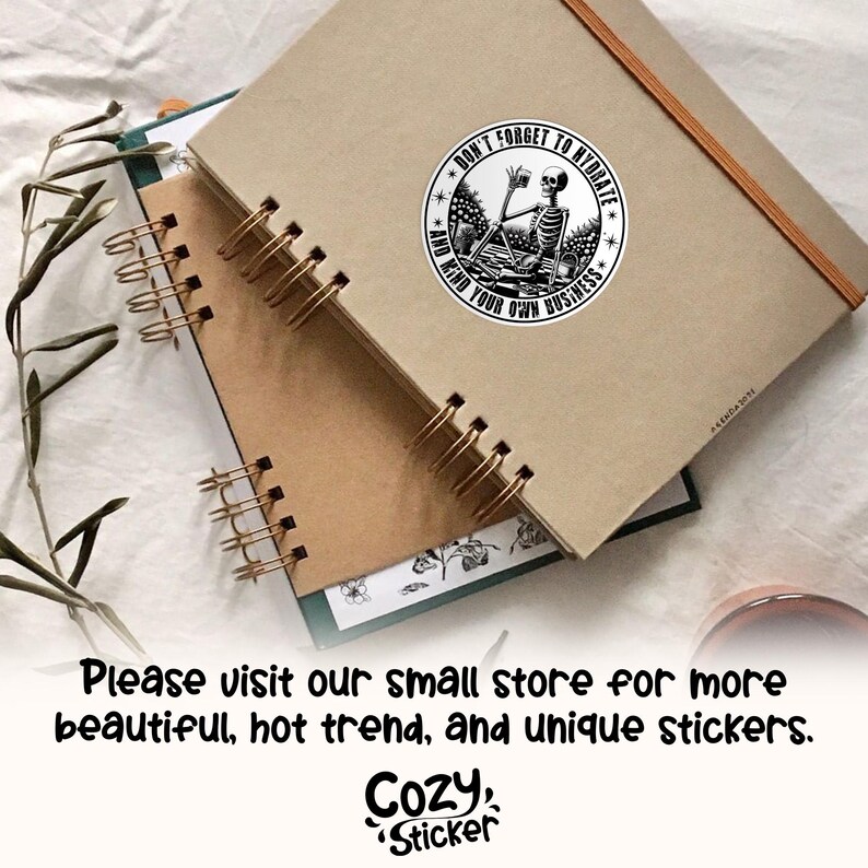 May include: A black and white sticker with a skeleton holding a glass of water and the text "Don't forget to hydrate and mind your own business".