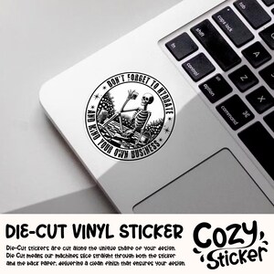 May include: Black and white die-cut vinyl sticker featuring a skeleton holding a glass of water with the text "Don't Forget to Hydrate and Mind Your Own Business".