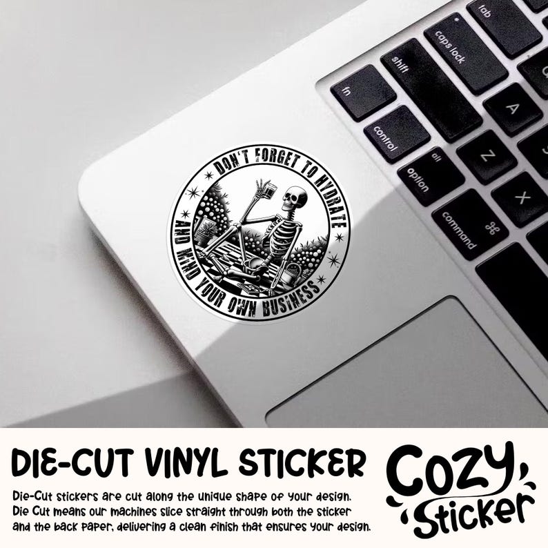 May include: Black and white die-cut vinyl sticker featuring a skeleton holding a glass of water with the text "Don't Forget to Hydrate and Mind Your Own Business".