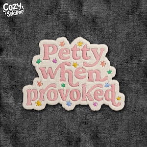 May include: Embroidered patch with the text "Petty When Provoked" in pink, surrounded by colorful star accents. The patch has a white border and is set against a dark denim background. The brand name "Cozy Sticker" is in the upper left corner.