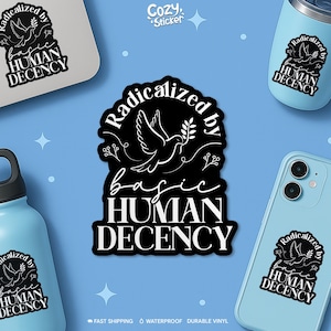 May include: Black and white sticker with the text "Radicalized by basic HUMAN DECENCY" and a dove carrying an olive branch. The sticker is displayed on a laptop, phone, tumbler, and water bottle. The background is light blue.