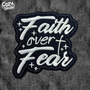 May include: Black and white embroidered patch with the text "Faith over Fear" in a stylized font. The patch has a distressed look and is surrounded by small white stars.