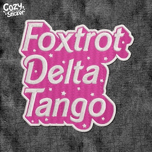May include: Pink fabric patch with white embroidered text that reads "Foxtrot Delta Tango".