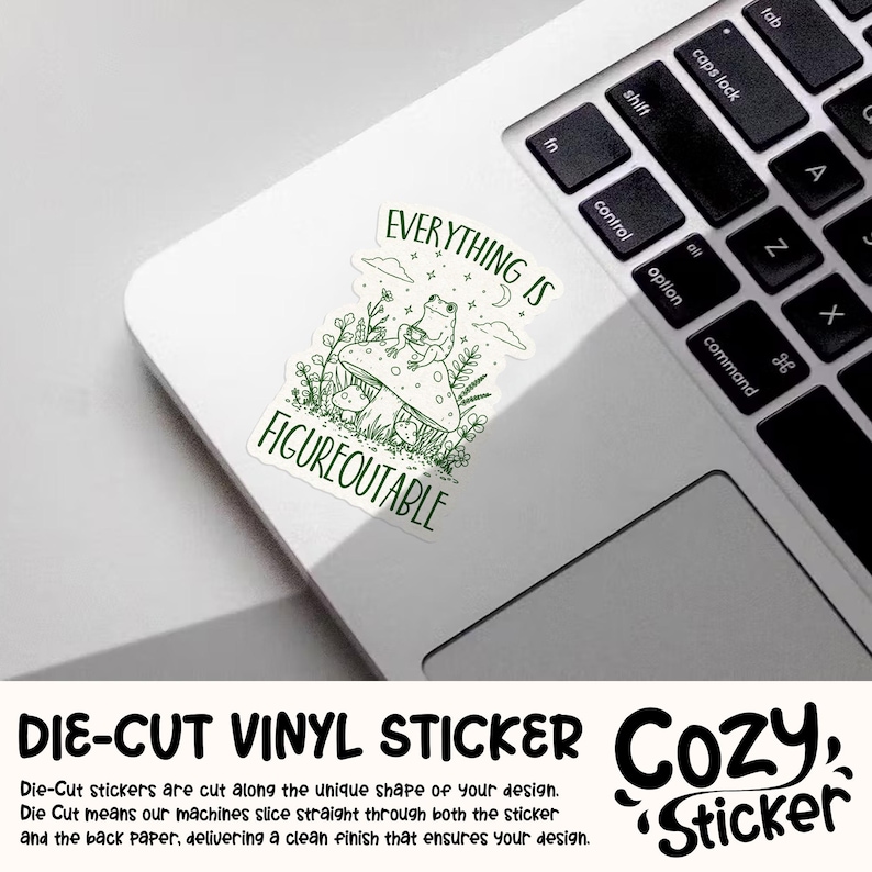 May include: A die-cut vinyl sticker with a green illustration of a frog on a mushroom, with the text "EVERYTHING IS FIGUREOUTABLE". The sticker is on a white laptop. The sticker is from Cozy Sticker.