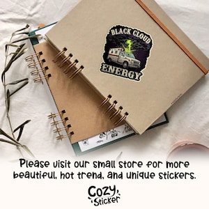 May include: A sticker featuring a white ambulance with a green lightning bolt and the words "BLACK CLOUD ENERGY". The sticker is on a tan notebook with spiral binding. The image also includes the text "Please visit our small store for more beautiful, hot trend, and unique stickers."