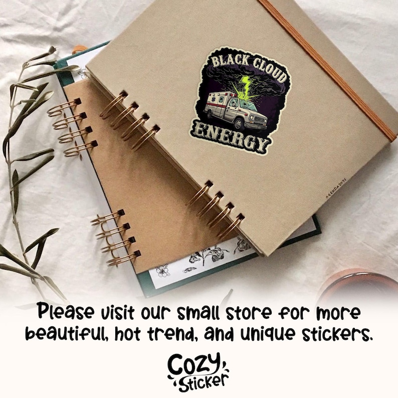 May include: A sticker featuring a white ambulance with a green lightning bolt and the words "BLACK CLOUD ENERGY". The sticker is on a tan notebook with spiral binding. The image also includes the text "Please visit our small store for more beautiful, hot trend, and unique stickers."