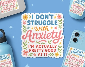 May include: A collection of white stickers with the text "I don't struggle with anxiety, I'm actually pretty good at it" in a floral design. The stickers are displayed on a laptop, a water bottle, a tumbler, and a phone. The background is light blue.