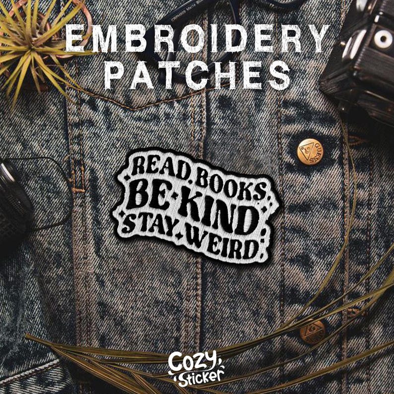 May include: White embroidered patch on a denim background. The patch says "Read Books Be Kind Stay Weird".